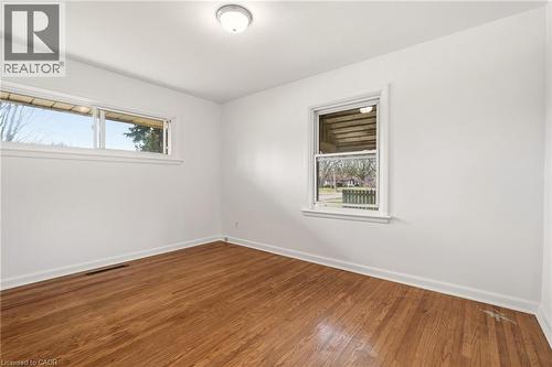 Empty room with baseboards and dark wood-style floors - 890 Falcon Boulevard, Burlington, ON - Indoor Photo Showing Other Room