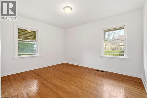 Spare room with wood-type flooring and baseboards - 890 Falcon Boulevard, Burlington, ON - Indoor Photo Showing Other Room