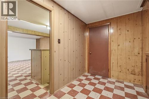 Hallway with light flooring and wood walls - 890 Falcon Boulevard, Burlington, ON - Indoor Photo Showing Other Room