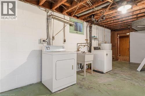 Laundry area featuring concrete flooring, washing machine and dryer, and water heater - 890 Falcon Boulevard, Burlington, ON - Indoor Photo Showing Laundry Room