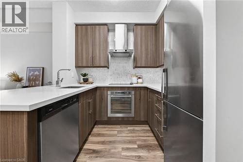 Modern and sleek kitchen. - 2081 Fairview Street Unit# 1402, Burlington, ON - Indoor Photo Showing Kitchen With Upgraded Kitchen