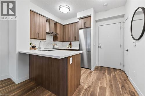 Room for stools for more casual dining. - 2081 Fairview Street Unit# 1402, Burlington, ON - Indoor Photo Showing Kitchen