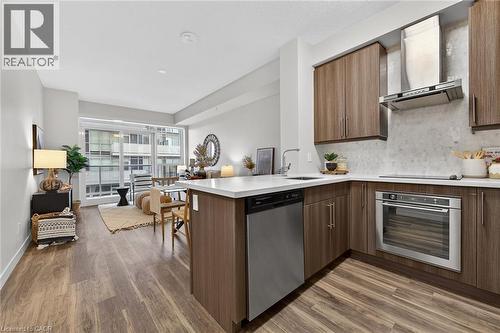 Sleek stainless appliances included. - 2081 Fairview Street Unit# 1402, Burlington, ON - Indoor Photo Showing Kitchen