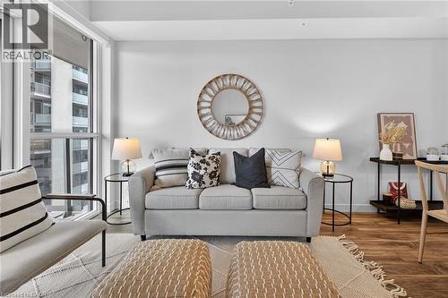 Loads of natural light flood the living area - 2081 Fairview Street Unit# 1402, Burlington, ON - Indoor Photo Showing Living Room