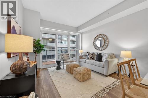 Warm and inviting space with views of the balcony. - 2081 Fairview Street Unit# 1402, Burlington, ON - Indoor Photo Showing Living Room