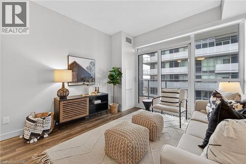 Living room offers easy access to the balcony. - 2081 Fairview Street Unit# 1402, Burlington, ON - Indoor