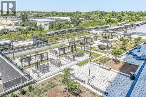 Outdoor BBQ Space complete with patio dining furnishings and views of the Go Station. - 2081 Fairview Street Unit# 1402, Burlington, ON - Outdoor