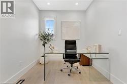 Office featuring light wood finished floors and recessed lighting - 