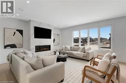 Living area featuring light wood-type flooring, a fireplace, and recessed lighting - 