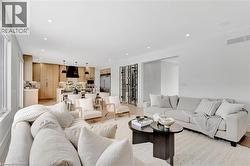 Living room with recessed lighting and light wood-style floors - 