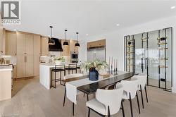 Dining space with light wood finished floors and recessed lighting - 