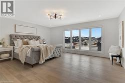 Bedroom with light wood-type flooring and recessed lighting - 