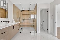 Bathroom with vanity, a stall shower, light marble finish flooring, and recessed lighting - 