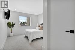 Bedroom featuring light colored carpet and recessed lighting - 