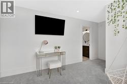 Bedroom featuring light carpet, ensuite bath, and recessed lighting - 