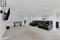 Cinema room featuring light carpet and recessed lighting - 