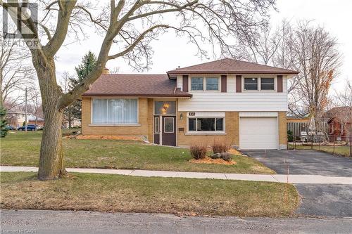Split level home featuring brick siding, asphalt driveway, and an attached garage - 135 Burbank Road, Kitchener, ON - Outdoor With Facade