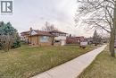 Tri-level home with asphalt driveway, an attached garage, brick siding, and a chimney - 135 Burbank Road, Kitchener, ON  - Outdoor 