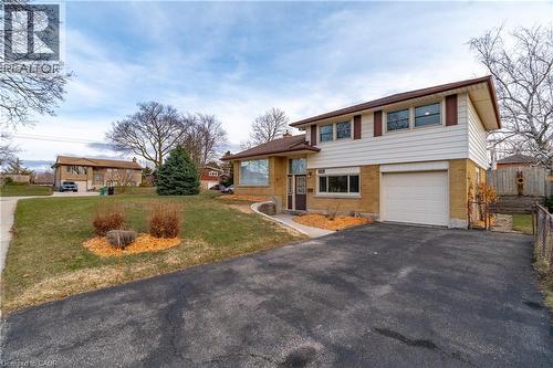 Tri-level home with brick siding, asphalt driveway, and an attached garage - 135 Burbank Road, Kitchener, ON - Outdoor