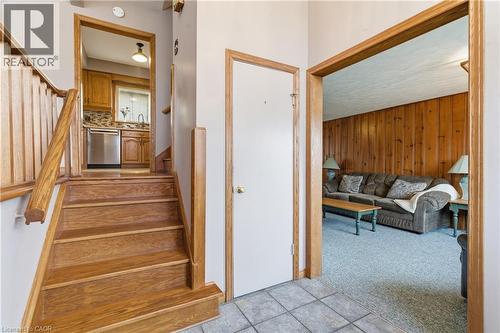 Wooden stairs, tile patterned floors, and carpet - 135 Burbank Road, Kitchener, ON - Indoor Photo Showing Other Room