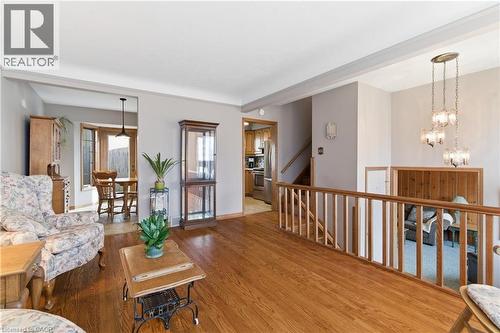 Living room featuring wood finished floors and hanging lights - 135 Burbank Road, Kitchener, ON - Indoor Photo Showing Living Room