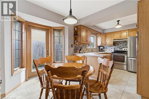 Dining room with light tile patterned flooring and baseboards - 135 Burbank Road, Kitchener, ON - Indoor Photo Showing Dining Room