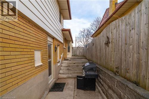 View of property exterior featuring brick siding and a patio - 135 Burbank Road, Kitchener, ON - Outdoor With Exterior