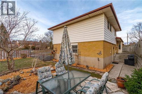 Rear view of property with outdoor dining area, brick siding, and a patio area - 135 Burbank Road, Kitchener, ON - Outdoor With Deck Patio Veranda