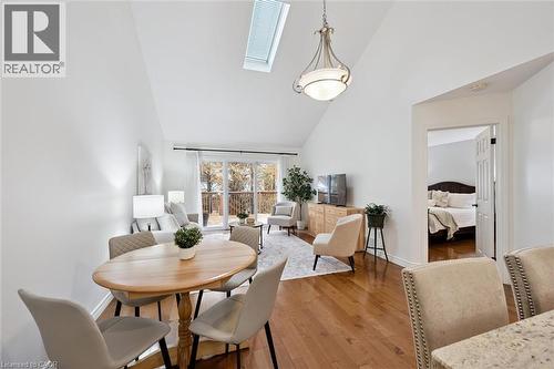 Dining room with a skylight, high vaulted ceiling, and hardwood / wood-style floors - 92 Schroder Crescent, Guelph, ON - Indoor Photo Showing Dining Room