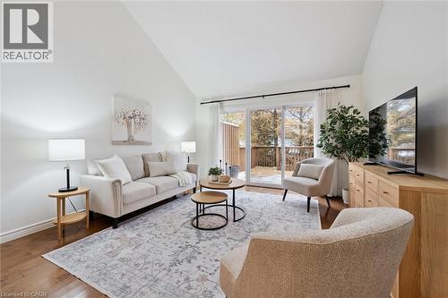Living area featuring wood finished floors and high vaulted ceiling - 92 Schroder Crescent, Guelph, ON - Indoor Photo Showing Living Room