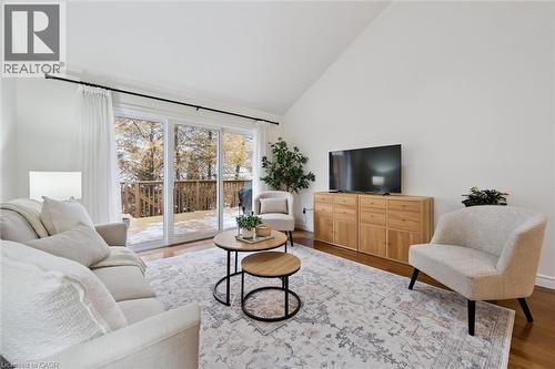 Living area with wood finished floors and high vaulted ceiling - 92 Schroder Crescent, Guelph, ON - Indoor Photo Showing Living Room