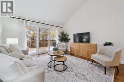 Living area with wood finished floors and high vaulted ceiling - 