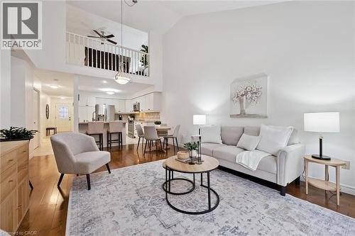 Living room featuring dark wood-style floors, a ceiling fan, and high vaulted ceiling - 92 Schroder Crescent, Guelph, ON - Indoor Photo Showing Living Room