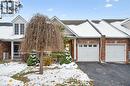 View of front of property with brick siding, driveway, an attached garage, and a porch - 92 Schroder Crescent, Guelph, ON  - Outdoor 