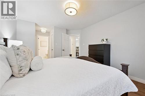 Bedroom with wood finished floors and connected bathroom - 92 Schroder Crescent, Guelph, ON - Indoor Photo Showing Bedroom