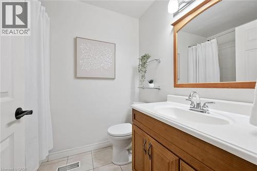 Bathroom featuring vanity, light tile patterned floors, and curtained shower - 92 Schroder Crescent, Guelph, ON - Indoor Photo Showing Bathroom