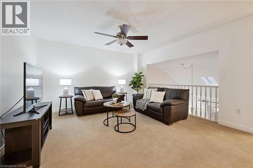 Living area featuring light colored carpet and ceiling fan - 92 Schroder Crescent, Guelph, ON - Indoor Photo Showing Other Room