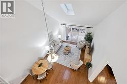 Living area with a skylight and wood finished floors - 