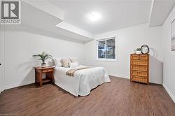 Bedroom with wood finished floors and baseboards - 