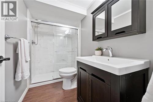 Bathroom featuring vanity, a shower stall, dark wood-style floors, and crown molding - 92 Schroder Crescent, Guelph, ON - Indoor Photo Showing Bathroom