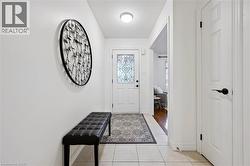 Doorway with tile patterned flooring and a textured ceiling - 