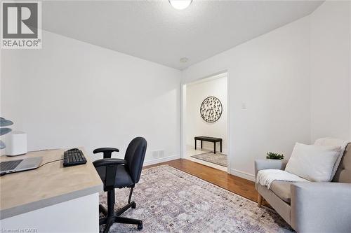 Office space with wood finished floors and a textured ceiling - 92 Schroder Crescent, Guelph, ON - Indoor