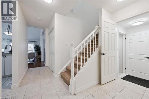 Foyer with stairs, light tile patterned floors, and a textured ceiling - 92 Schroder Crescent, Guelph, ON - Indoor Photo Showing Other Room