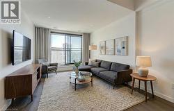 Living room featuring baseboards and dark wood finished floors - 