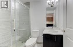 Ensuite bathroom featuring vanity and a stall shower - 