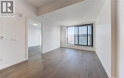 Empty room featuring dark wood finished floors and recessed lighting - 