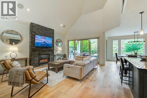 Main level living space with backyard views. - 425 Audubon Court, Kelowna, BC - Indoor Photo Showing Living Room With Fireplace