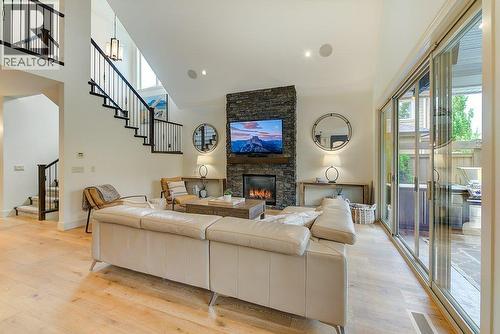 Cozy gas fireplace with rock surround - 425 Audubon Court, Kelowna, BC - Indoor Photo Showing Living Room With Fireplace