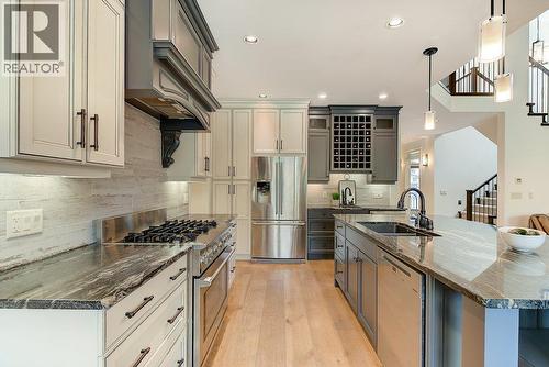 Gourmet kitchen with top-of-the-line appliances - 425 Audubon Court, Kelowna, BC - Indoor Photo Showing Kitchen With Upgraded Kitchen