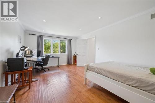 Bedroom with a desk, ornamental molding, light wood-style floors, and recessed lighting - 599 Beechwood Drive, Waterloo, ON - Indoor Photo Showing Bedroom